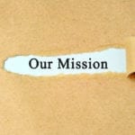 Ripped paper with "our mission" text.